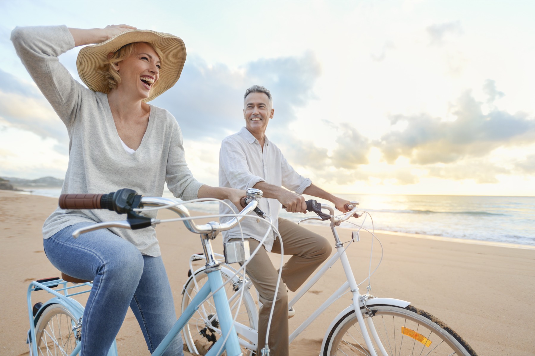 Een stel fietst samen langs het strand